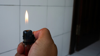 hand holding a burning match