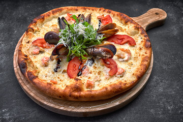 Pizza with seafood on dark