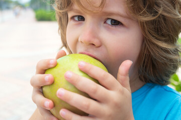Fototapeta premium Kid boy eat apple. Healthy nutrition for kids. Fruit snack. Lunch time.