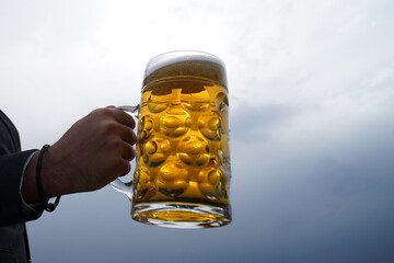Man hand hold cup glass of beer. Beer mugs.