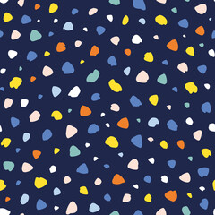 Abstract hand drawn dots and irregular shapes randomly placed seamless repeat pattern. Multicolor confetti like all over print with dark blue background.