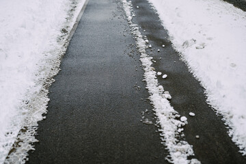 sidewalk cleared of snow in winter