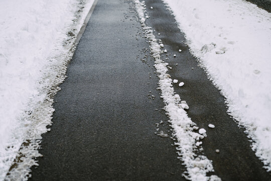 sidewalk cleared of snow in winter