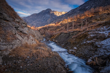 Fototapeta na wymiar Tortum creek near the waterfall in wintertime in Uzundere, Erzurum, Turkey. January 2021