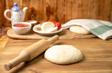 Fototapeta na wymiar DIY pizza at home, dough and pizza gotoa go to the oven