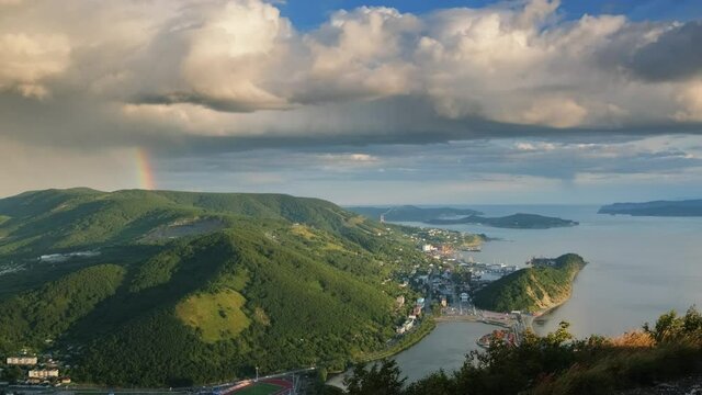 Storm clouds and raindow over Petropavlovsk-Kamchatsky City, Avacha Bay, Pacific Ocean and seaport. Russian Far East, Kamchatka Peninsula, 4k