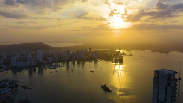 Spectacular Golden Sunrise in Cartagena, Colombia. Drone Flying Backwards Reveals Cartagena Skyline at Sunrise