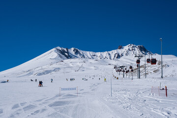 ERCIYES, TURKEY - FEBRUARY 2021: View of the ski slopes and chair lifts at Mount Erciyes ski area, February 2021, in Kayseri, Turkey. Mount Erciyes ski area is one of the longest slope in Turkey