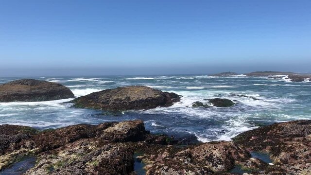 Waves of Pacific Ocean hitting shores near Pacific Rim National Park Reserve - popular surfing destination located between Tofino and Ucluelet on the west side of Vancouver Island 