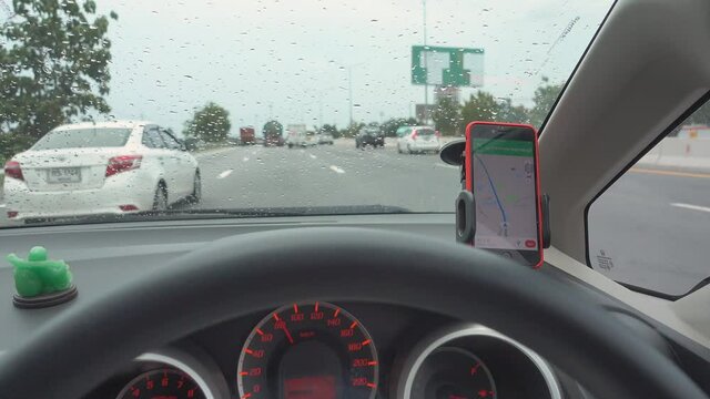 The map gps navigation on modern smartphone device gadget mounted on phone holder in car dashboard doing driving on the expressway go to destination 