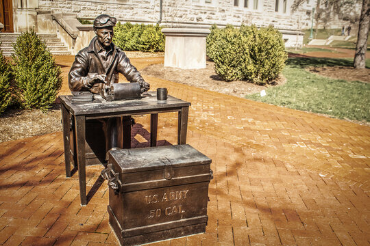 03_23_2021 Bloomington USA Bronze statue of historic US miliary man with typewriter and Army chest and google sitting in on campus of Indiana University.