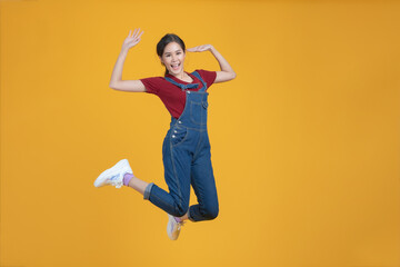 Fototapeta na wymiar Asian woman jumping by happy face..