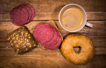 Breakfast table with rolls, coffee and sausage - top down view - food photography