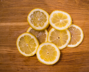 Fototapeta na wymiar Sliced lemon slices on a wooden table - food photography
