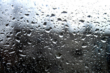 Raindrops on the window. Glass fogging and evaporation. Rain outside the window.