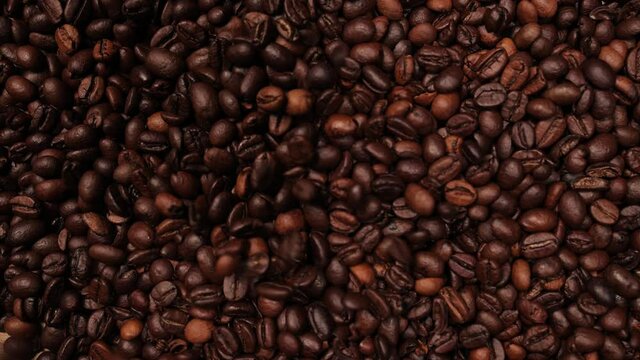 Coffee beans falling in slow motion on a table - food photography
