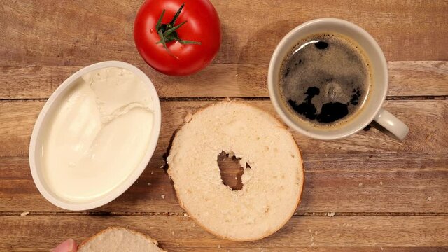 Sprinkle freshly baked bagel with Cream Cheese - food photography