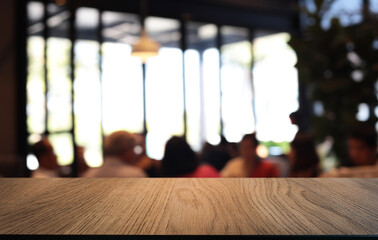 Empty wooden table in front of abstract blurred background of coffee shop . can be used for display or montage your products.Mock up for display of product