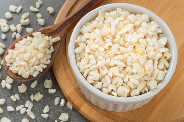 Bowl with grains of hominy. Detail of wooden spoon and bamboo support.
