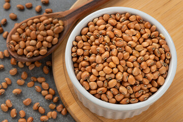 Bowl with string bean grains. Detail of wooden spoon and bamboo holder.