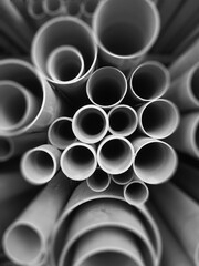 Multi size pvc pipe on the metal rack in black and white