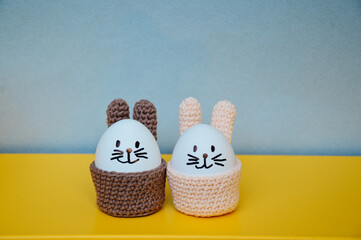 Easter holiday preparation. Crocheted egg basket in the shape of an Easter bunny. Egg stand in the...