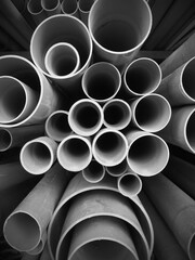 Multi size pvc pipe on the metal rack in black and white