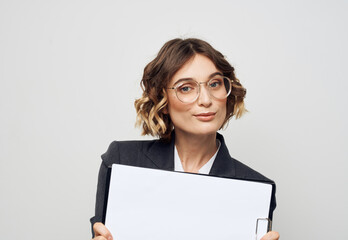 Woman in business suit with white sheet of paper at work glasses mockup