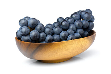 Black  grape in wooden bowl isolated on white 