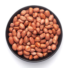Macro Close up of organic red-brown peanuts (Arachis hypogaea) on a black Ceramic bowl, Top View
