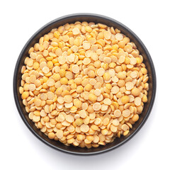 Macro Close-up of Organic arhar dal (Cajanus cajan) or split yellow dal on a ceramic black bowl. Top view 