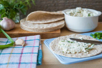 Pita bread and salty cottage cheese with herbs
