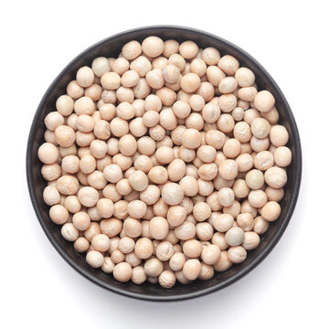 Macro Close up of Close up of Organic dry peas whole (Pisum sativum) or matar dal on a ceramic black bowl. Top view 