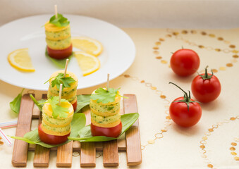Appetizer. Canapes of cheese, cream cheese with garlic, parsley, basil, sorrel and cherry tomatoes.