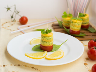 Appetizer. Canapes of cheese, cream cheese with garlic, parsley, basil, sorrel and cherry tomatoes.