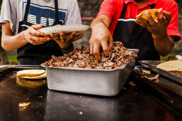 cooking Mexican tacos with beef, traditional street food in Mexico city