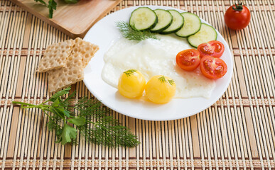 Breakfast - fried eggs (with raw frozen yolk) and vegetables
