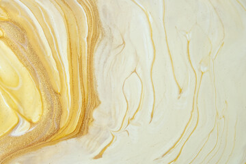 Abstract fluid art background yellow and golden colors. Liquid marble. Acrylic painting with ocher...