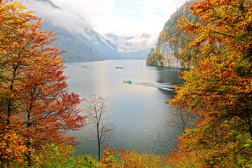 View of Koenigssee ( King's Lake) surrounded by alpine mountains from Malerwinkel viewpoint in colorful autumn season ~ Beautiful scenery of Bavarian countryside in Berchtesgaden Germany