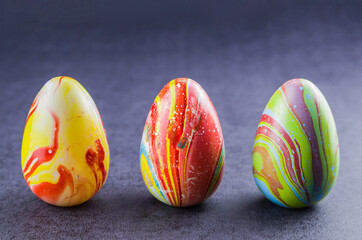 Colorful Easter eggs lined up side by side.