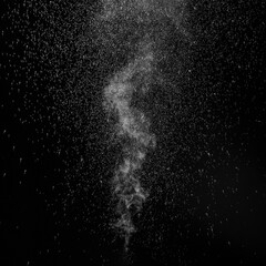 Curly white steam rising up and splashing water scattering in different directions isolated on a...