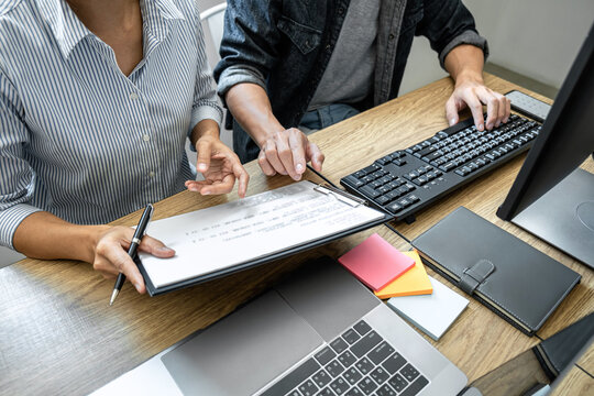 Programmer Team of  Developing programming and website working in a software develop company office, writing codes and typing data code, Programming with HTML, PHP and javascript