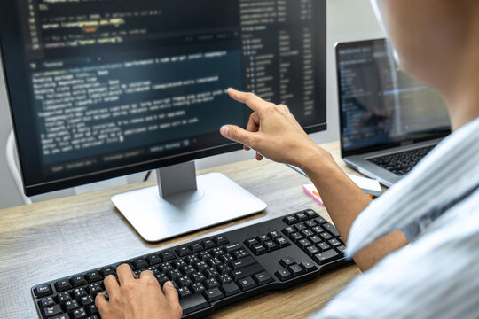 Programmer Team of  Developing programming and website working in a software develop company office, writing codes and typing data code, Programming with HTML, PHP and javascript