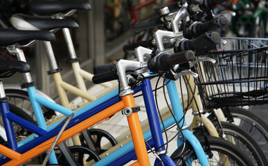 Fototapeta na wymiar Many colorful bicycle saddles and handlebars