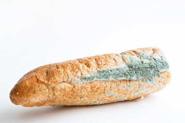 Blue mildew fungus on white bread close-up. Spoiled food, unhealthy food. White background