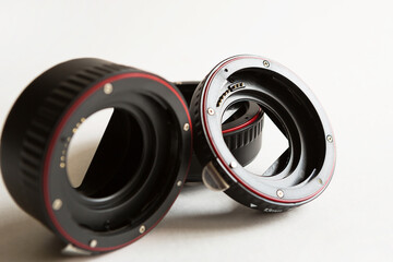 Macro rings for camera lens close-up on a gray background. Professional macro photography,...