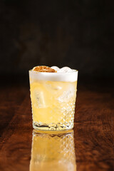 Citrus sour cocktail on the wooden table with reflection