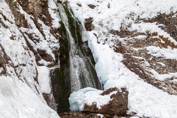 Fototapeta na wymiar A frozen waterfall with ice in winter