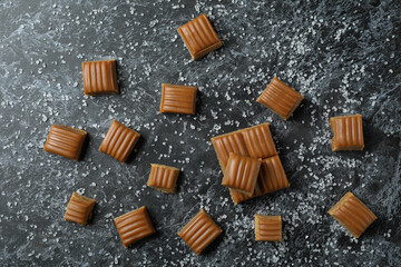 Salted caramel pieces on black smoky background