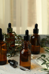 Tray with bottles of eucalyptus oil and branches